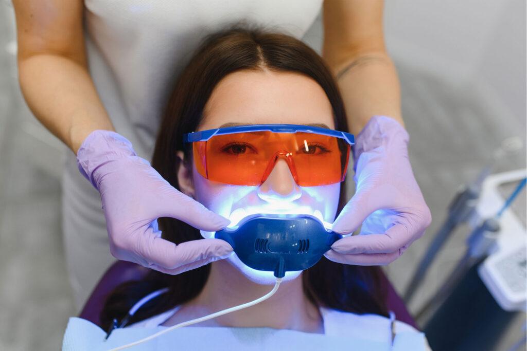 dentist applying Zoom whitening gel in Carlsbad