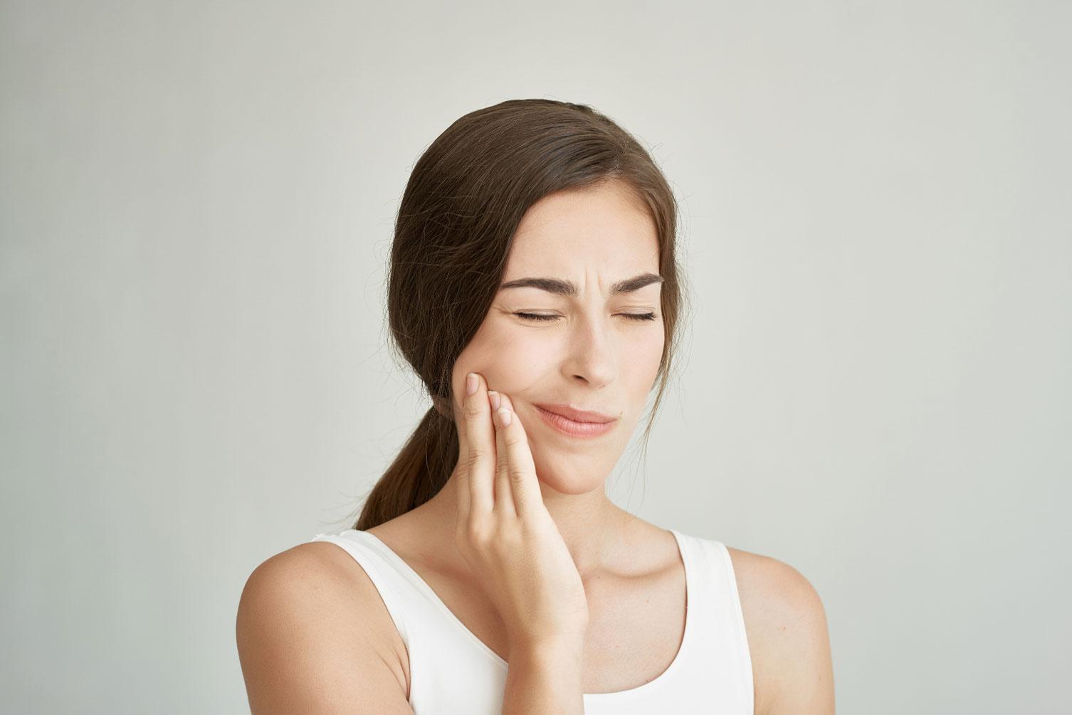 young adult with wisdom tooth pain and jaw swelling
