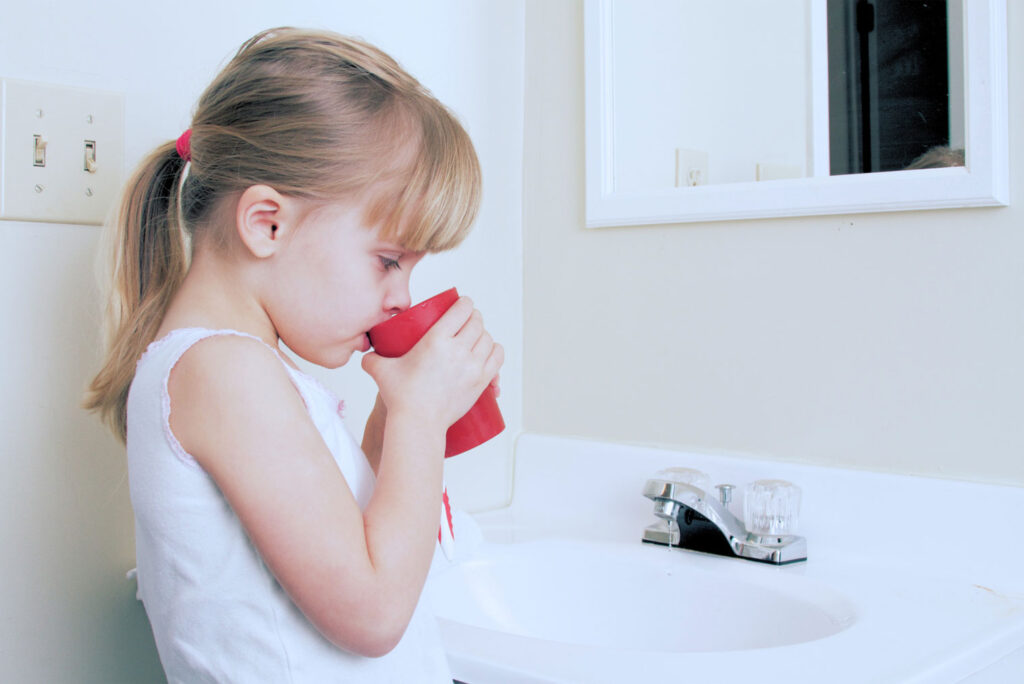 child learning to floss for improve your smile
