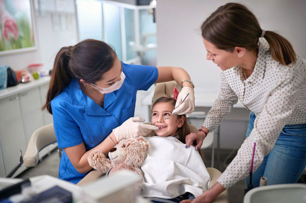 toddler dental checkup with parent holding child