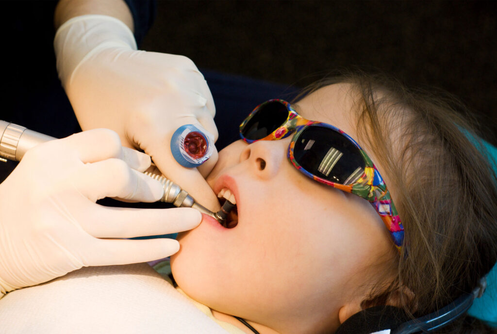 child holding comfort glasses during dentist appointment to reduce anxiety