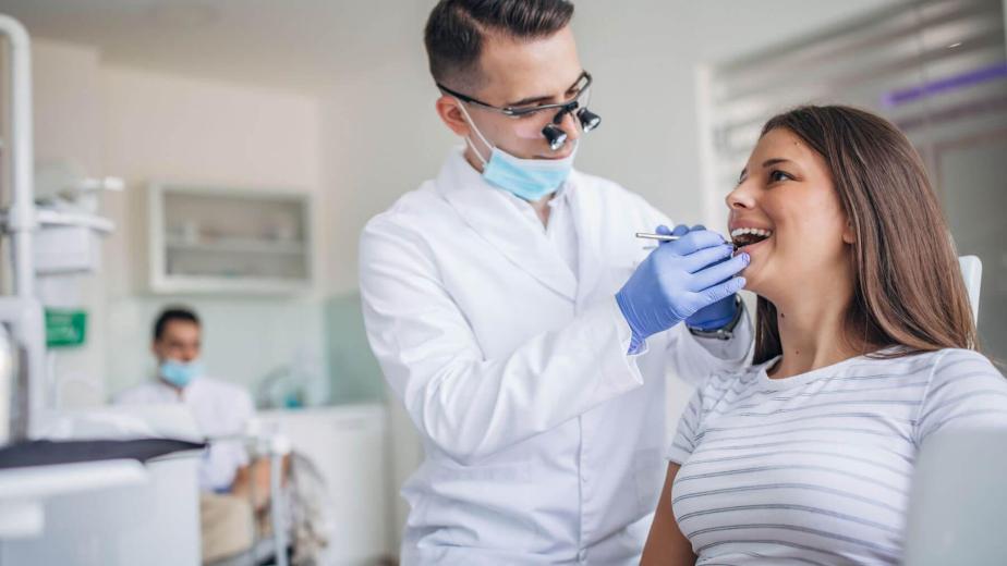 Dental hygienist check for a deep dental cleaning to remove tartar below the gumline