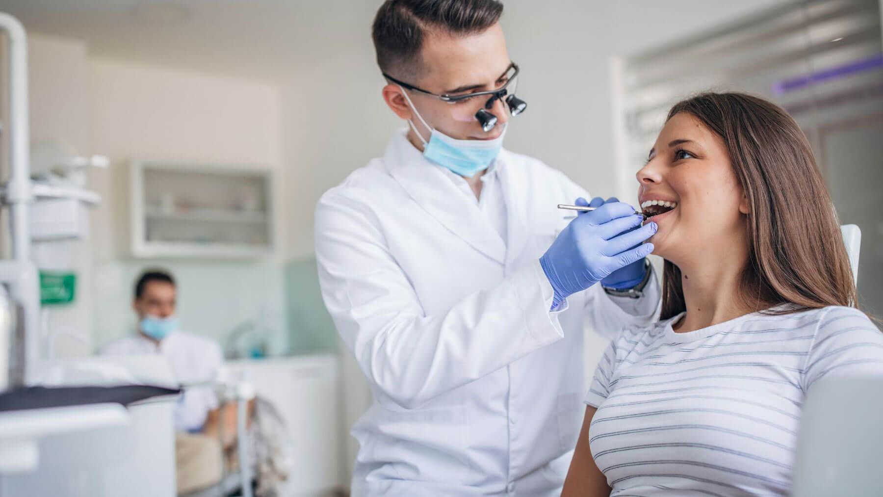 Dental hygienist check for a deep dental cleaning to remove tartar below the gumline